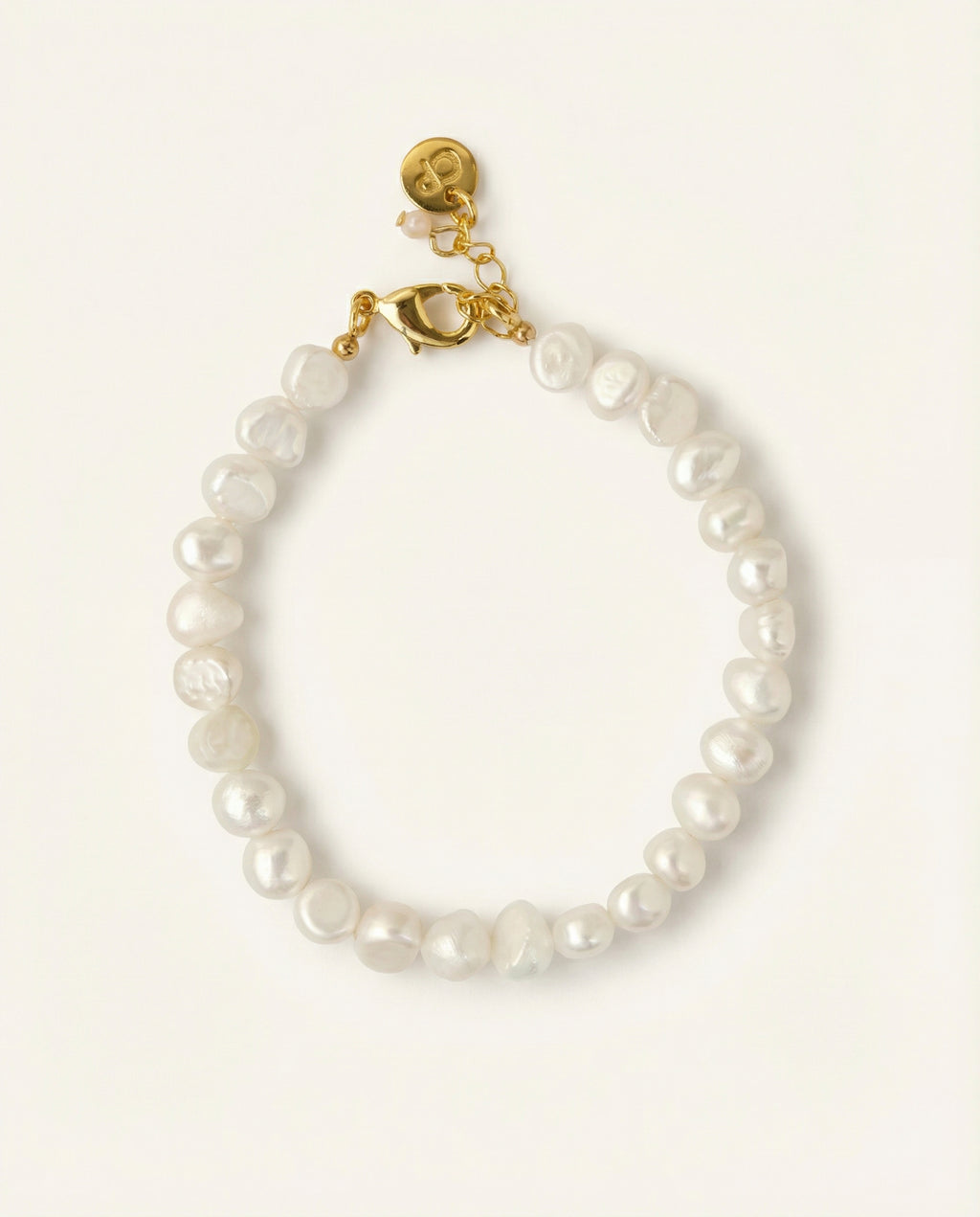 Pearl bracelet on beige background