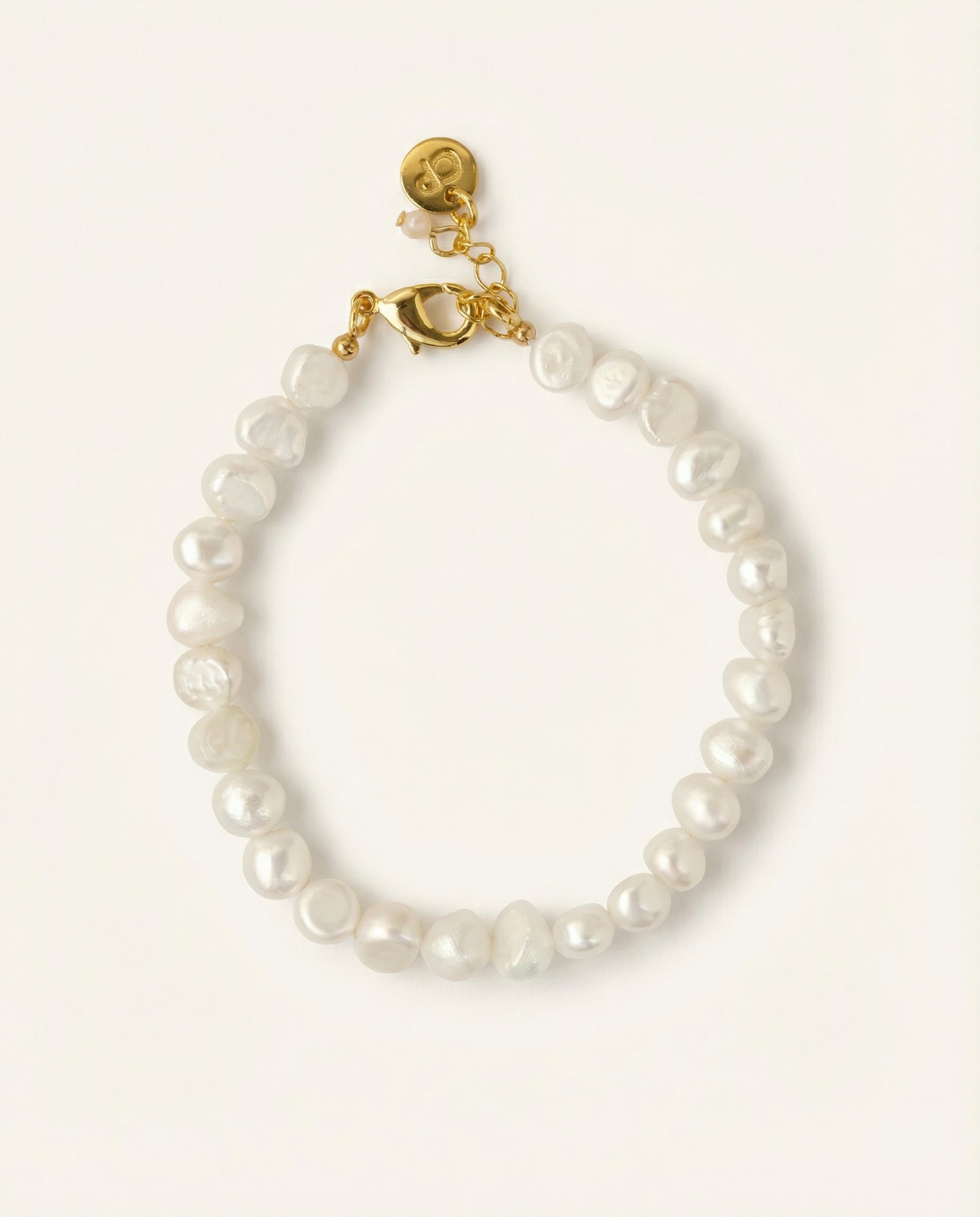Pearl bracelet on beige background