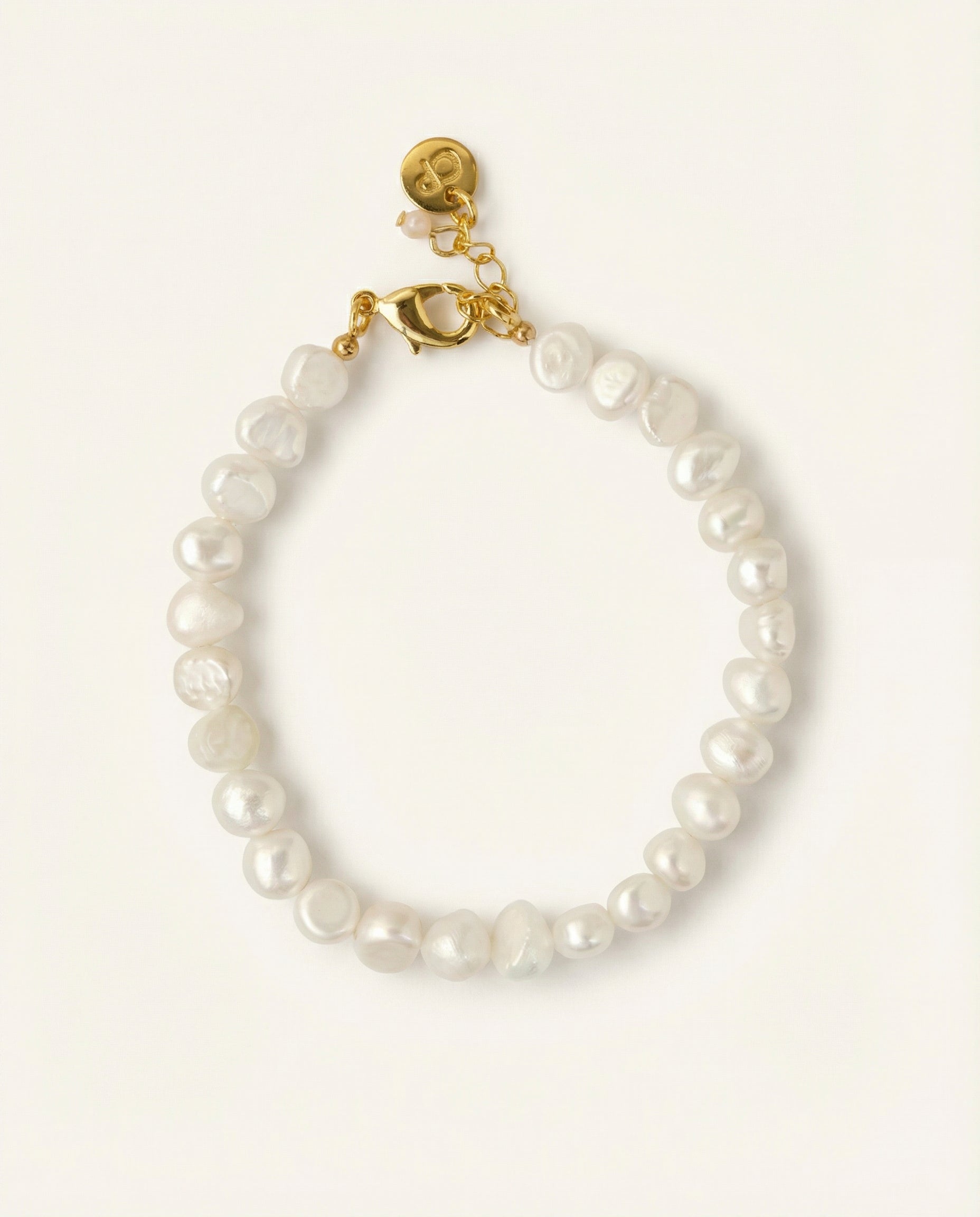 Pearl bracelet on beige background