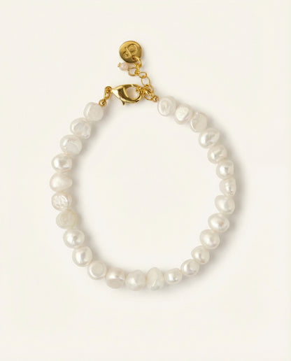 Pearl bracelet on beige background