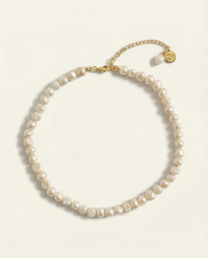 Pearl necklace with gold clasp on a white background