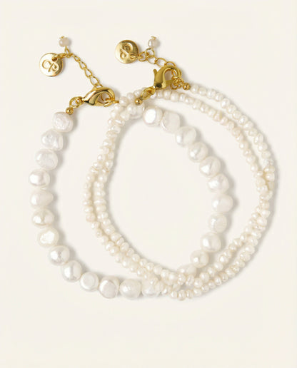 Pearl bracelet with gold clasp on a white background
